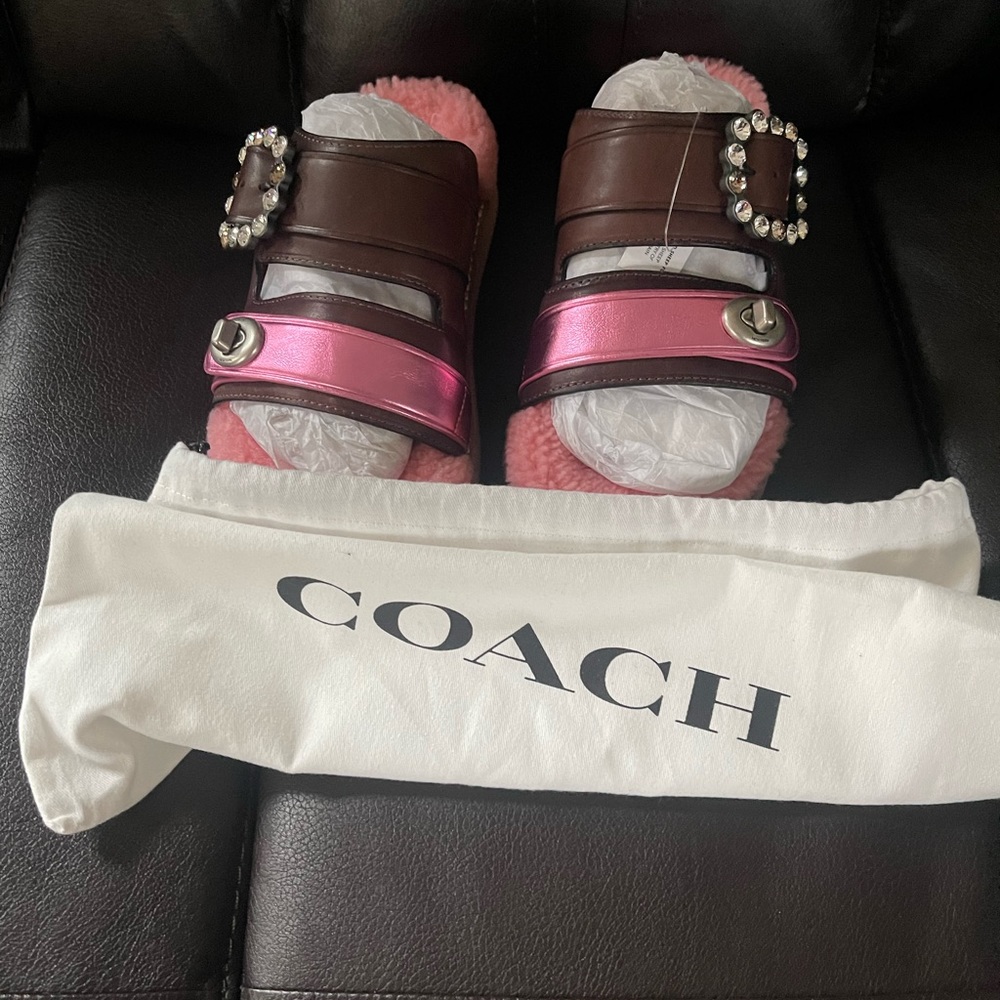 Coach slip on shoes. Has a platform.